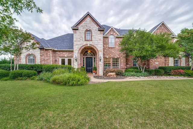 2841 Winding Creek Rd, Prosper, TX 75078 - view of front of house with a front yard, brick siding, and roof with shingles