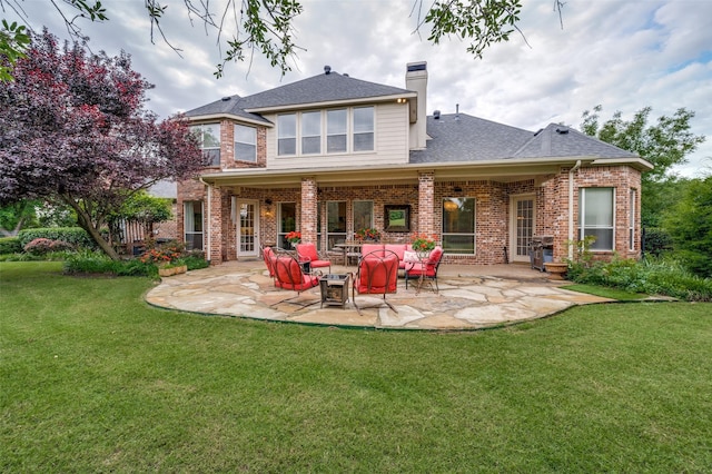 2841 Winding Creek Rd, Prosper, TX 75078 - rear view of house with a patio area, brick siding, a chimney, and a lawn