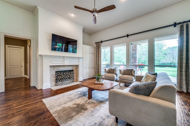 2841 Winding Creek Rd, Prosper, TX 75078 - living room featuring ornamental molding, a high ceiling, a ceiling fan, wood finished floors, and a tiled fireplace