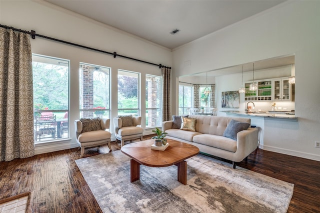 2841 Winding Creek Rd, Prosper, TX 75078 - living room with wood finished floors, crown molding, and baseboards