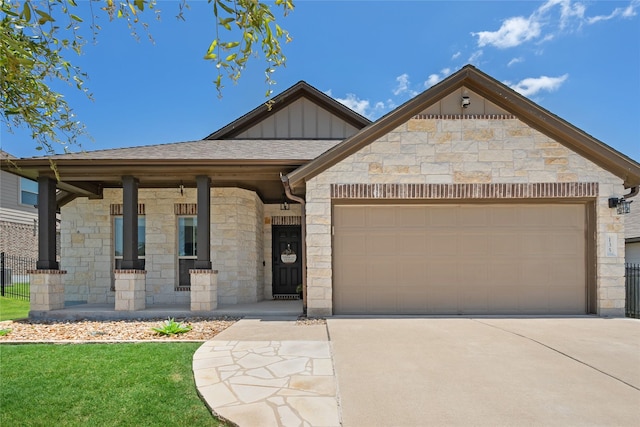 135 Pine Island Ln, Leander, TX 78641 - view of front facade with stone siding, board and batten siding, concrete driveway, and a garage