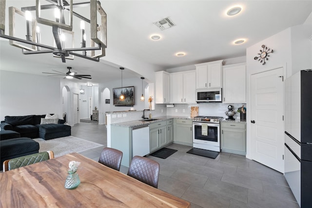 135 Pine Island Ln, Leander, TX 78641 - living area with a ceiling fan, arched walkways, healthy amount of natural light, and light tile patterned floors