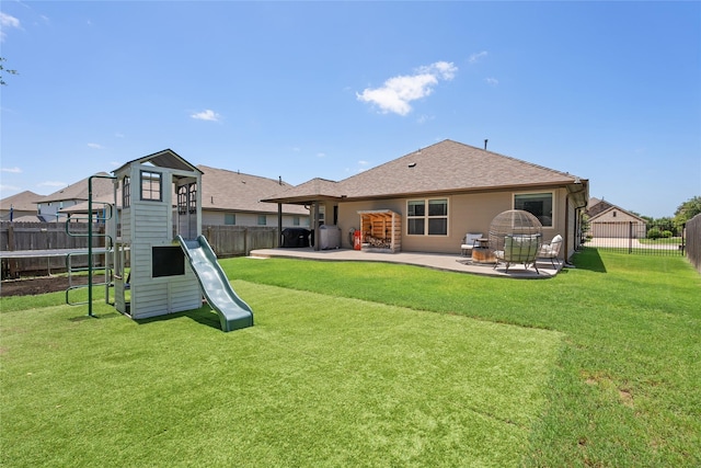 135 Pine Island Ln, Leander, TX 78641 - rear view of property featuring a playground, a patio, and a shingled roof