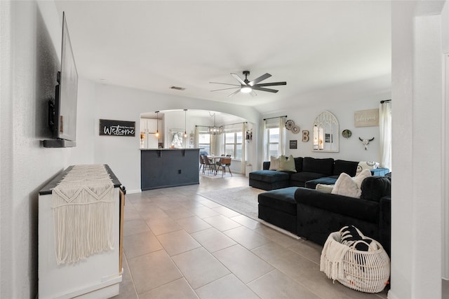 135 Pine Island Ln, Leander, TX 78641 - kitchen featuring white appliances, arched walkways, tasteful backsplash, ceiling fan, and open floor plan