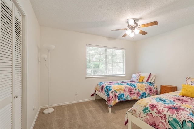 12752 Honeysuckle Cir, Eustace, TX 75124 - carpeted bedroom featuring a closet, a textured ceiling, and a ceiling fan