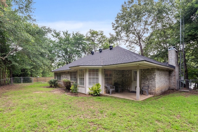 12752 Honeysuckle Cir, Eustace, TX 75124 - back of property featuring a chimney, a patio area, a fenced backyard, a shingled roof, and a gate