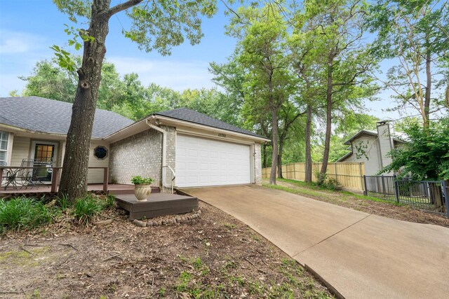 12752 Honeysuckle Cir, Eustace, TX 75124 - view of side of property with a garage, driveway, brick siding, a shingled roof, and a wooden deck
