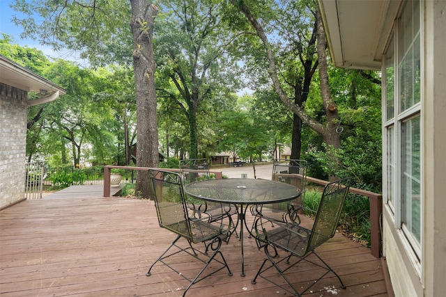 12752 Honeysuckle Cir, Eustace, TX 75124 - wooden deck featuring outdoor dining space and view of wooded area