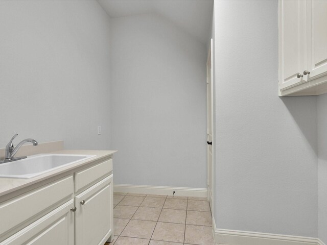 14875 Story Ln, Frisco, TX 75035 - washroom with a sink, baseboards, and light tile patterned floors