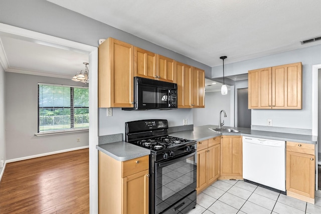 2969 Eric Ln, Farmers Branch, TX 75234 - kitchen with black appliances, ornamental molding, pendant lighting, light brown cabinetry, and a chandelier