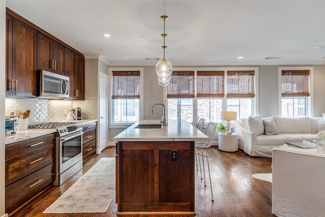 4121 Grassmere Ln Unit 3, University Park, TX 75205 - kitchen with appliances with stainless steel finishes, a sink, dark wood-type flooring, light countertops, and dark brown cabinetry