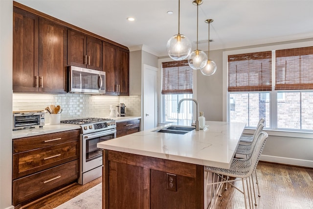 4121 Grassmere Ln Unit 3, University Park, TX 75205 - kitchen featuring appliances with stainless steel finishes, a sink, light wood-style floors, plenty of natural light, and recessed lighting