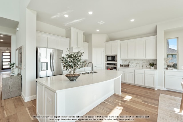 411 Atlas Cedar Dr, Glenn Heights, TX 75154 - kitchen with appliances with stainless steel finishes, a sink, tasteful backsplash, white cabinets, and recessed lighting