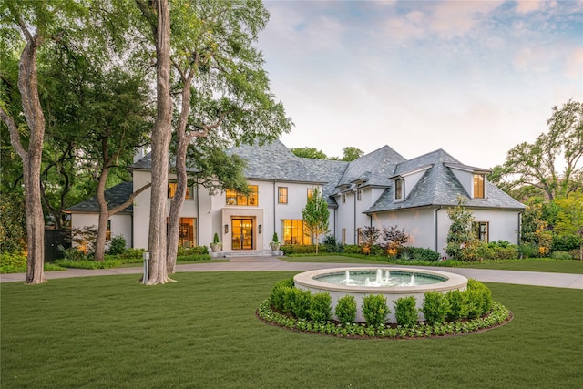 4222 Cochran Chapel Rd, Dallas, TX 75209 - french country home featuring stucco siding, a front yard, and curved driveway