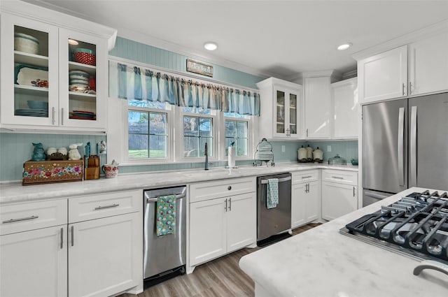 1016 Crestview Dr, Sherman, TX 75092 - kitchen featuring appliances with stainless steel finishes, white cabinets, light wood-style flooring, glass insert cabinets, and recessed lighting