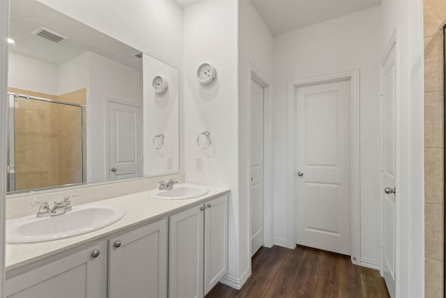797 Hawthorn St, Princeton, TX 75407 - full bath featuring double vanity, a tile shower, and wood finished floors