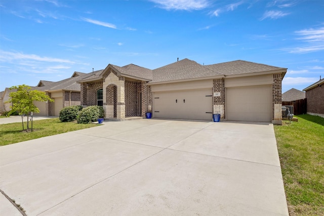 797 Hawthorn St, Princeton, TX 75407 - view of front facade featuring brick siding, a garage, driveway, and a front yard