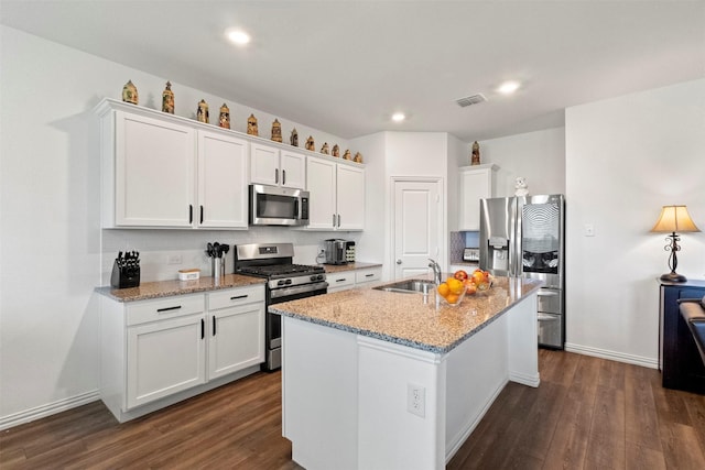 797 Hawthorn St, Princeton, TX 75407 - kitchen featuring stainless steel appliances, dark wood finished floors, white cabinets, a kitchen island with sink, and recessed lighting