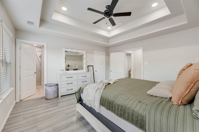 5414 Wild Oak Rd, Balch Springs, TX 75180 - bedroom featuring a raised ceiling, recessed lighting, light wood-type flooring, connected bathroom, and ceiling fan