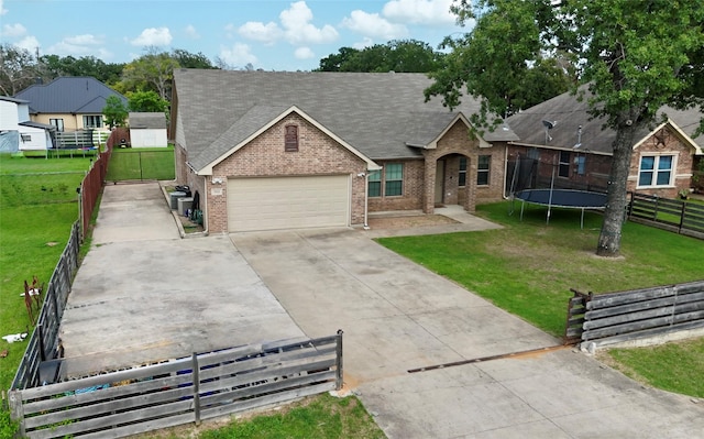 5414 Wild Oak Rd, Balch Springs, TX 75180 - view of front of home featuring brick siding, a trampoline, an attached garage, concrete driveway, and roof with shingles