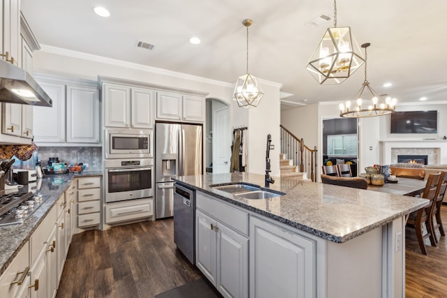 608 Ambrose St, Fort Worth, TX 76131 - kitchen with appliances with stainless steel finishes, a sink, dark wood-style flooring, open floor plan, and ornamental molding