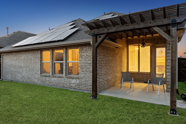 608 Ambrose St, Fort Worth, TX 76131 - back of property featuring brick siding, roof mounted solar panels, ceiling fan, a patio area, and a shingled roof