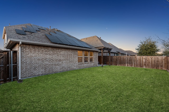 608 Ambrose St, Fort Worth, TX 76131 - back of house with roof mounted solar panels, brick siding, and roof with shingles