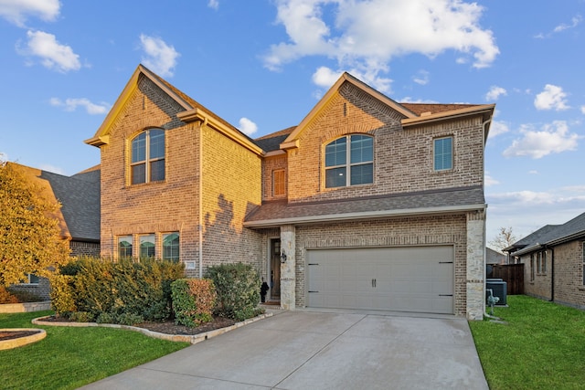 608 Ambrose St, Fort Worth, TX 76131 - traditional-style house with brick siding, a front yard, driveway, a garage, and central air condition unit