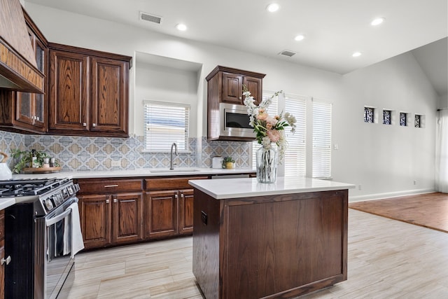 1208 Claire St, Lantana, TX 76226 - kitchen with appliances with stainless steel finishes, light countertops, decorative backsplash, recessed lighting, and a center island