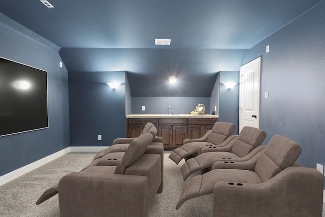 1208 Claire St, Lantana, TX 76226 - carpeted home theater room with wet bar and lofted ceiling
