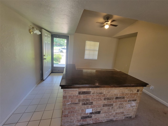 1340 Finley Dr, Plano, TX 75025 - kitchen with a ceiling fan, dark countertops, baseboards, light tile patterned floors, and a textured ceiling