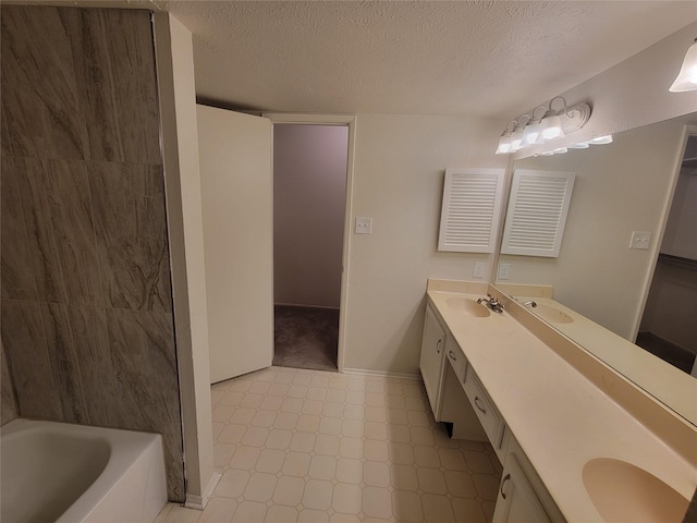 1340 Finley Dr, Plano, TX 75025 - full bathroom with double vanity, a textured ceiling, tile patterned floors, baseboards, and tub / shower combination
