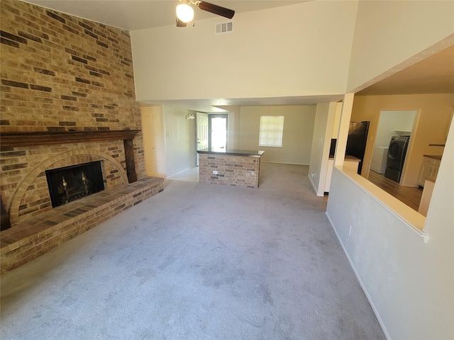 1340 Finley Dr, Plano, TX 75025 - unfurnished living room featuring washer / dryer, ceiling fan, baseboards, a brick fireplace, and carpet flooring