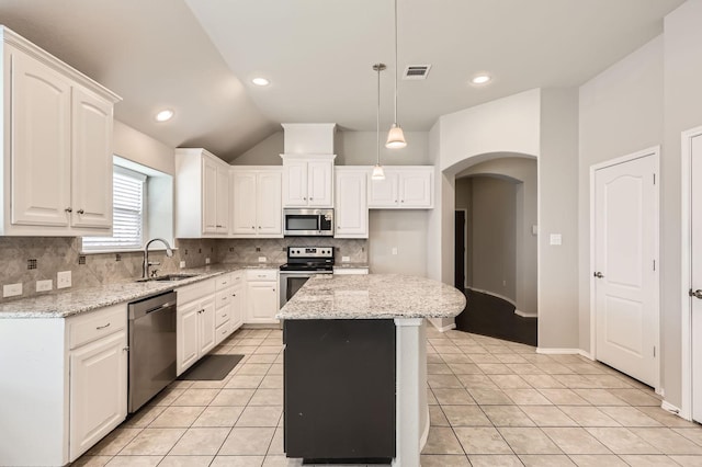 2124 Leonard Ranch Rd, Fort Worth, TX 76134 - kitchen with appliances with stainless steel finishes, a sink, backsplash, white cabinetry, and arched walkways