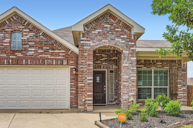 2124 Leonard Ranch Rd, Fort Worth, TX 76134 - view of front facade featuring brick siding, a shingled roof, a garage, and concrete driveway