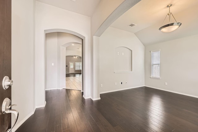 2124 Leonard Ranch Rd, Fort Worth, TX 76134 - foyer with healthy amount of natural light, dark wood-style flooring, arched walkways, vaulted ceiling, and baseboards