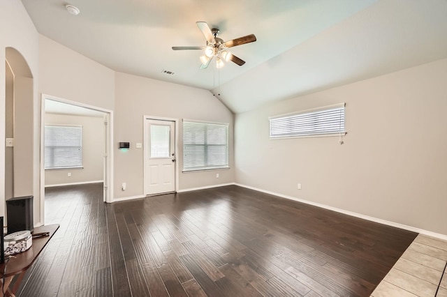 2124 Leonard Ranch Rd, Fort Worth, TX 76134 - unfurnished living room featuring a ceiling fan, arched walkways, vaulted ceiling, dark wood-style flooring, and baseboards