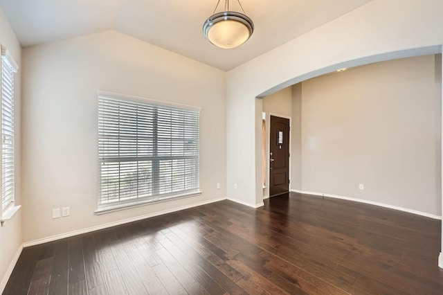 2124 Leonard Ranch Rd, Fort Worth, TX 76134 - empty room featuring arched walkways, dark wood finished floors, baseboards, and vaulted ceiling