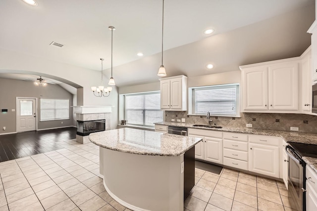 2124 Leonard Ranch Rd, Fort Worth, TX 76134 - kitchen with a sink, a tiled fireplace, appliances with stainless steel finishes, plenty of natural light, and recessed lighting