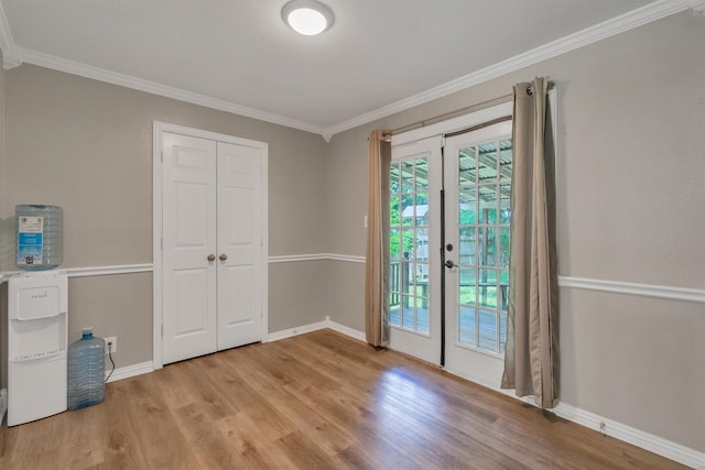 203 Olive St, Waxahachie, TX 75165 - unfurnished bedroom with light wood-type flooring, access to outside, ornamental molding, french doors, and a closet