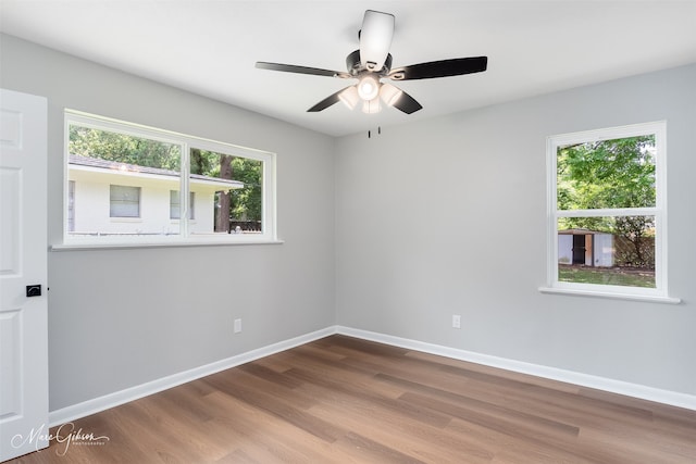2869 Alkay Dr, Shreveport, LA 71118 - empty room with plenty of natural light, wood finished floors, a ceiling fan, and baseboards