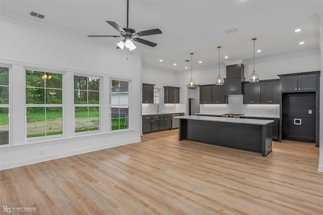 231 Ramsey, Stonewall, LA 71078 - kitchen featuring wall chimney exhaust hood, light countertops, backsplash, ceiling fan, and a center island
