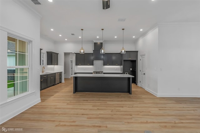 231 Ramsey, Stonewall, LA 71078 - kitchen featuring ornamental molding, light countertops, light wood finished floors, wall chimney exhaust hood, and hanging light fixtures