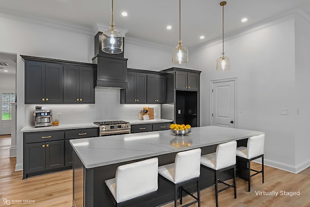 231 Ramsey, Stonewall, LA 71078 - kitchen with stainless steel gas range oven, tasteful backsplash, a breakfast bar, ornamental molding, and a center island