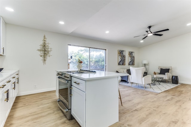 806 Brookshire Cir, Garland, TX 75043 - kitchen featuring stainless steel stove, light wood-style flooring, white cabinetry, and recessed lighting