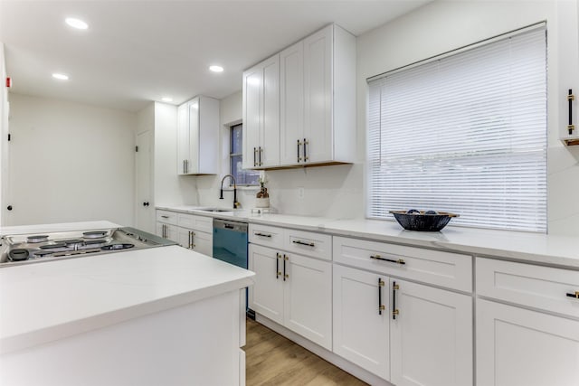 806 Brookshire Cir, Garland, TX 75043 - kitchen featuring a sink, white cabinets, recessed lighting, light wood-style flooring, and light stone countertops