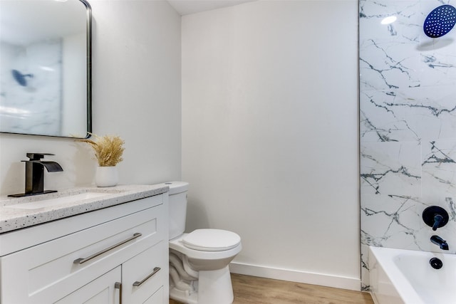 806 Brookshire Cir, Garland, TX 75043 - bathroom featuring vanity, wood finished floors, toilet, baseboards, and washtub / shower combination