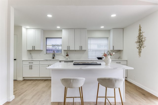 806 Brookshire Cir, Garland, TX 75043 - kitchen with a sink, a kitchen bar, healthy amount of natural light, a kitchen island, and recessed lighting