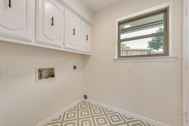 520 Oakcrest Dr, Coppell, TX 75019 - laundry room with cabinet space, washer hookup, baseboards, electric dryer hookup, and tile patterned floors