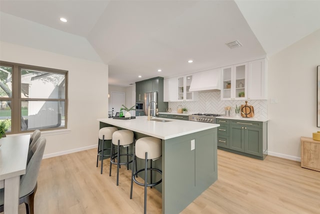 520 Oakcrest Dr, Coppell, TX 75019 - kitchen featuring green cabinets, white cabinets, custom exhaust hood, a sink, and tasteful backsplash